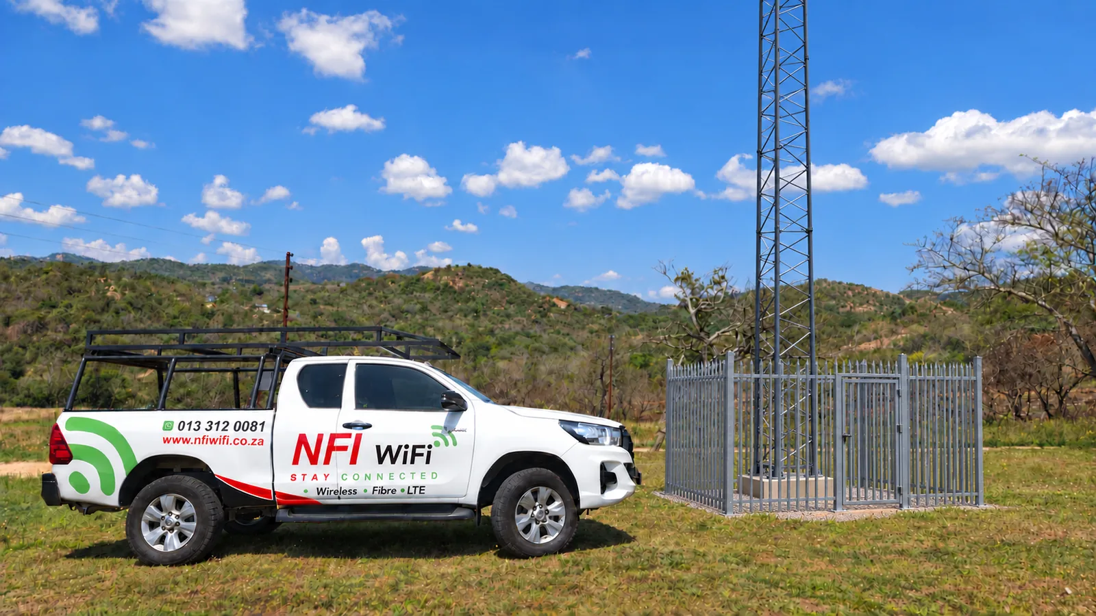 NFI WiFi service bakkie beside a fixed-wireless tower and palisade enclosure
